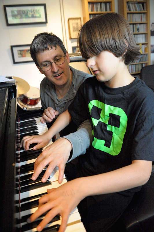 Photo: John giving his thirteen year old son Jasper a lesson.